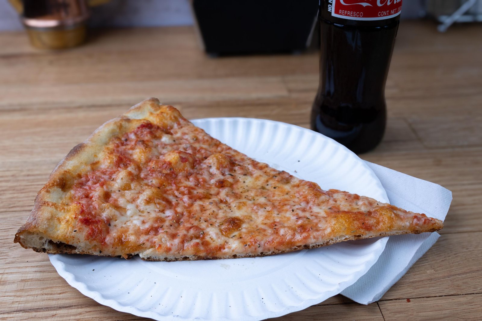 Charred crust detail on NY pizza slice